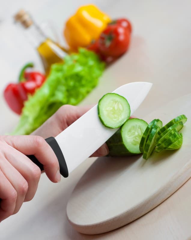 Do ceramic knives break easily; image shows slicing salad vegetables is no problem